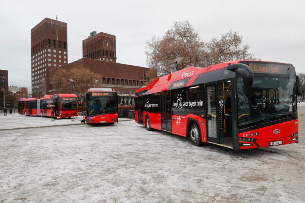 A fleet of red electric buses marked